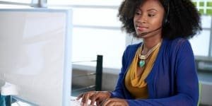 image of sales lady sitting at her computer